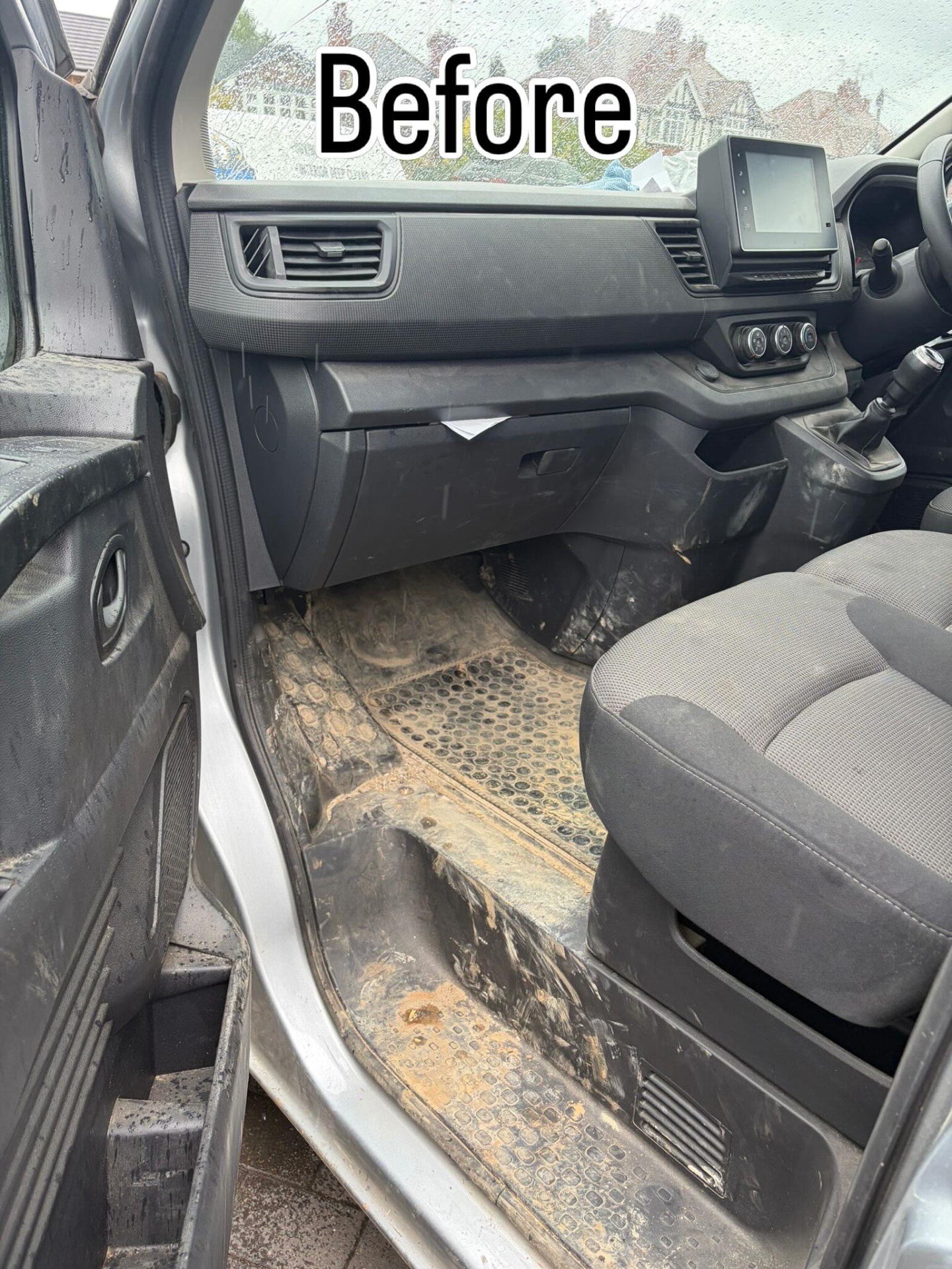 Van footwell before cleaning — ground-in dirt