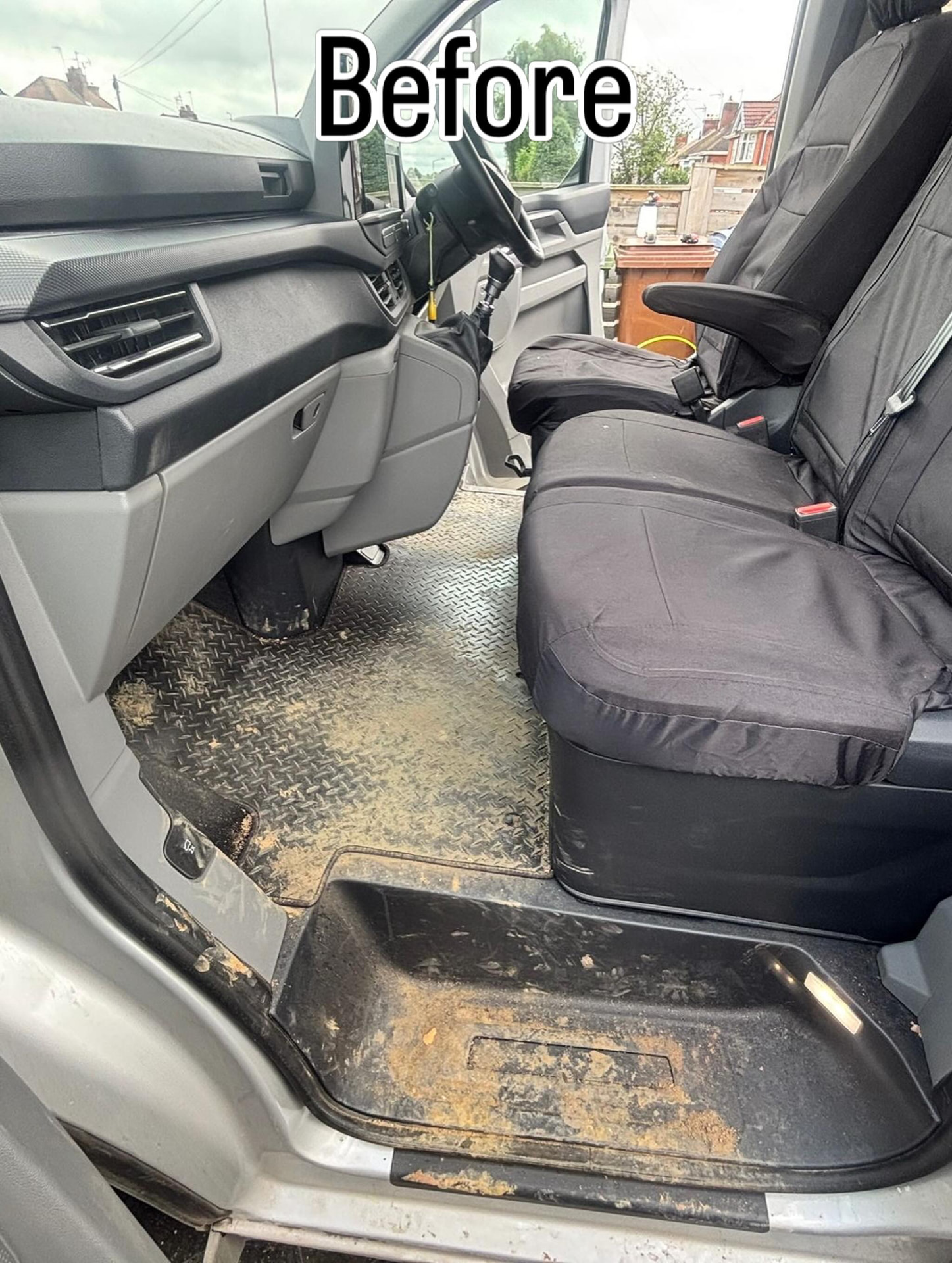 Van cab before cleaning — heavily soiled seats and trim